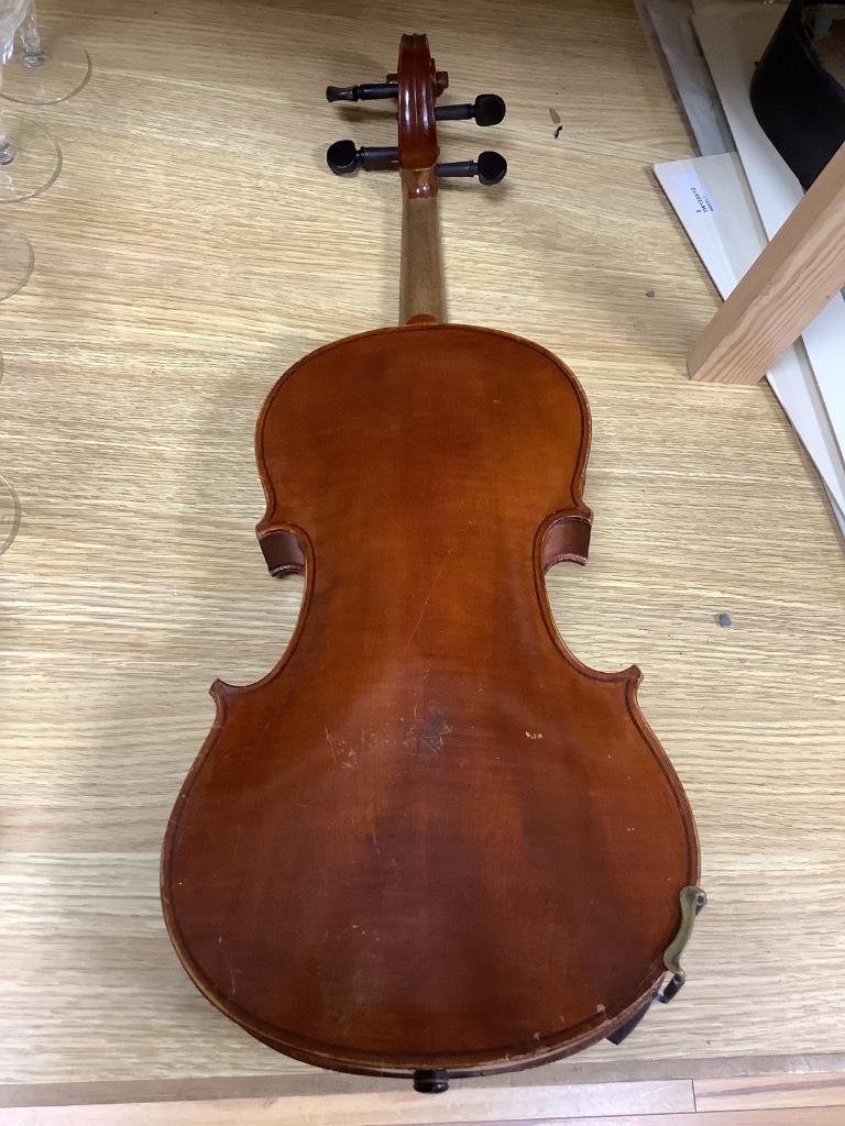 A violin and bow, in case, label to interior read Antonius Stadivarius Cremonensis, made in Czechoslovakia